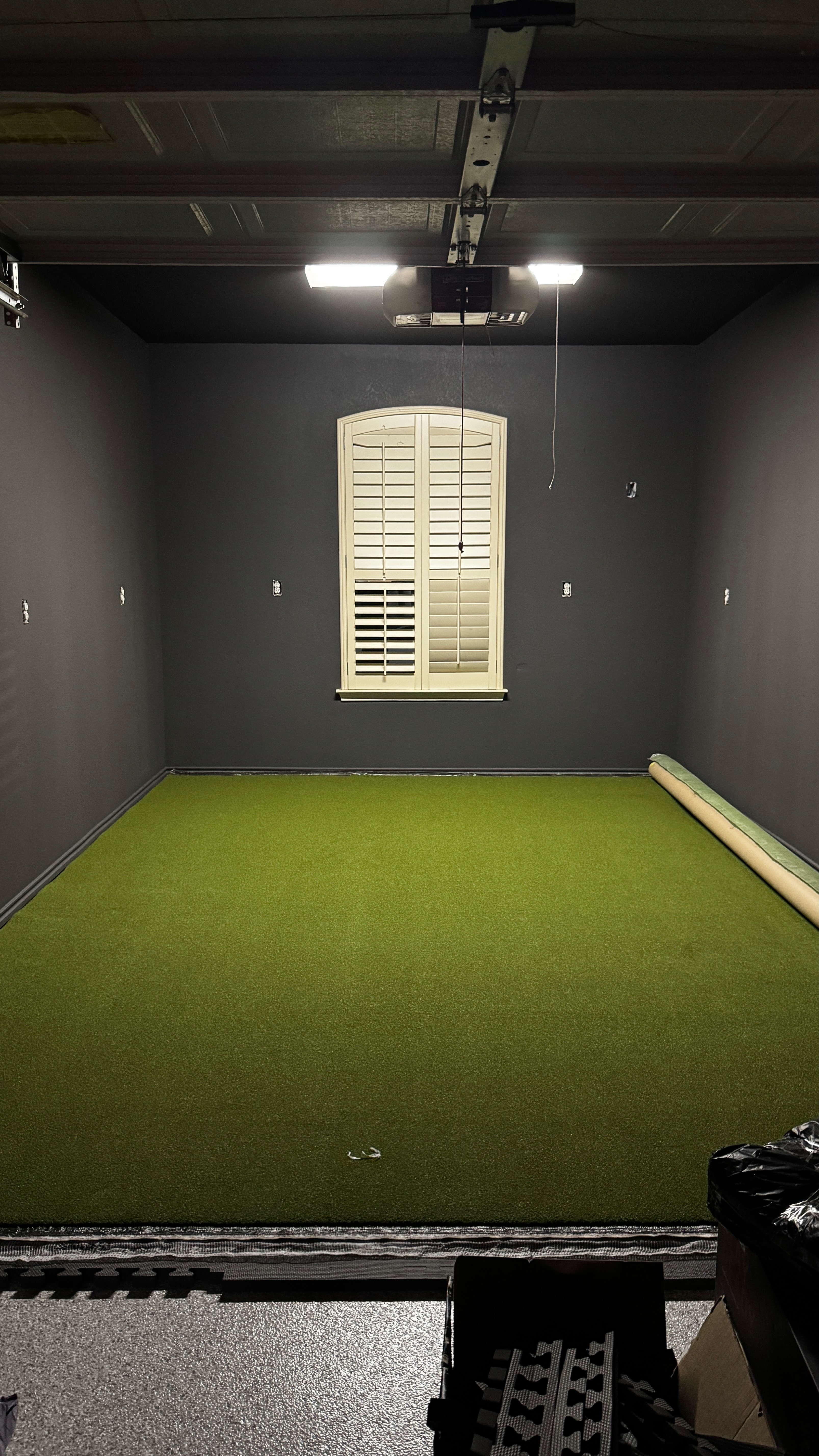 Finished golf simulator studio with synthetic turf